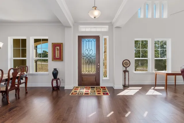a view of a livingroom with furniture window and wooden floor