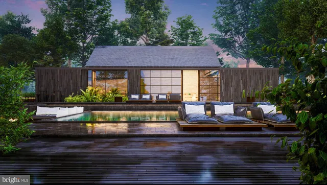 a front view of a house with garden and seating area