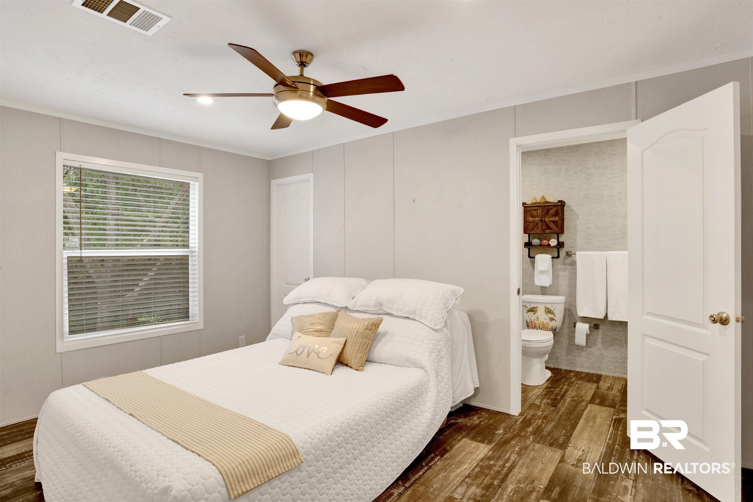 1411 Ridgewood Drive Lillian, AL 36549 - Photo 20 of 30 Bedroom with crown molding, dark hardwood / wood-style floors, ceiling fan, and ensuite bathroom