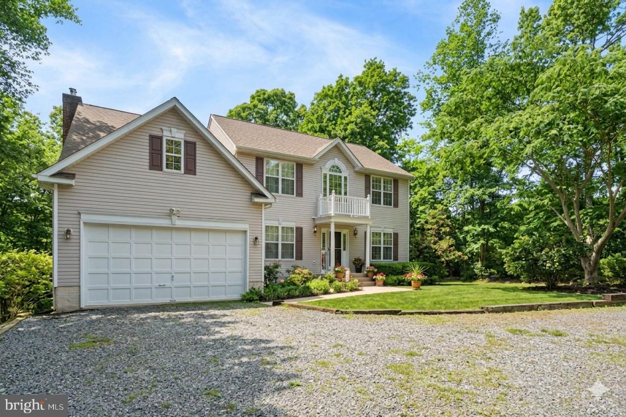 14760 Peach Tree Lane King George, VA 22485 - Photo 1 of 40 a front view of a house with a garden and trees