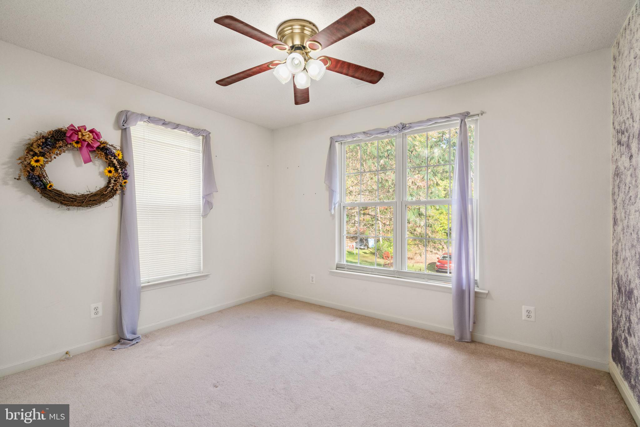 14760 Peach Tree Lane King George, VA 22485 - Photo 24 of 40 a view of an empty room with a window and a chandelier fan