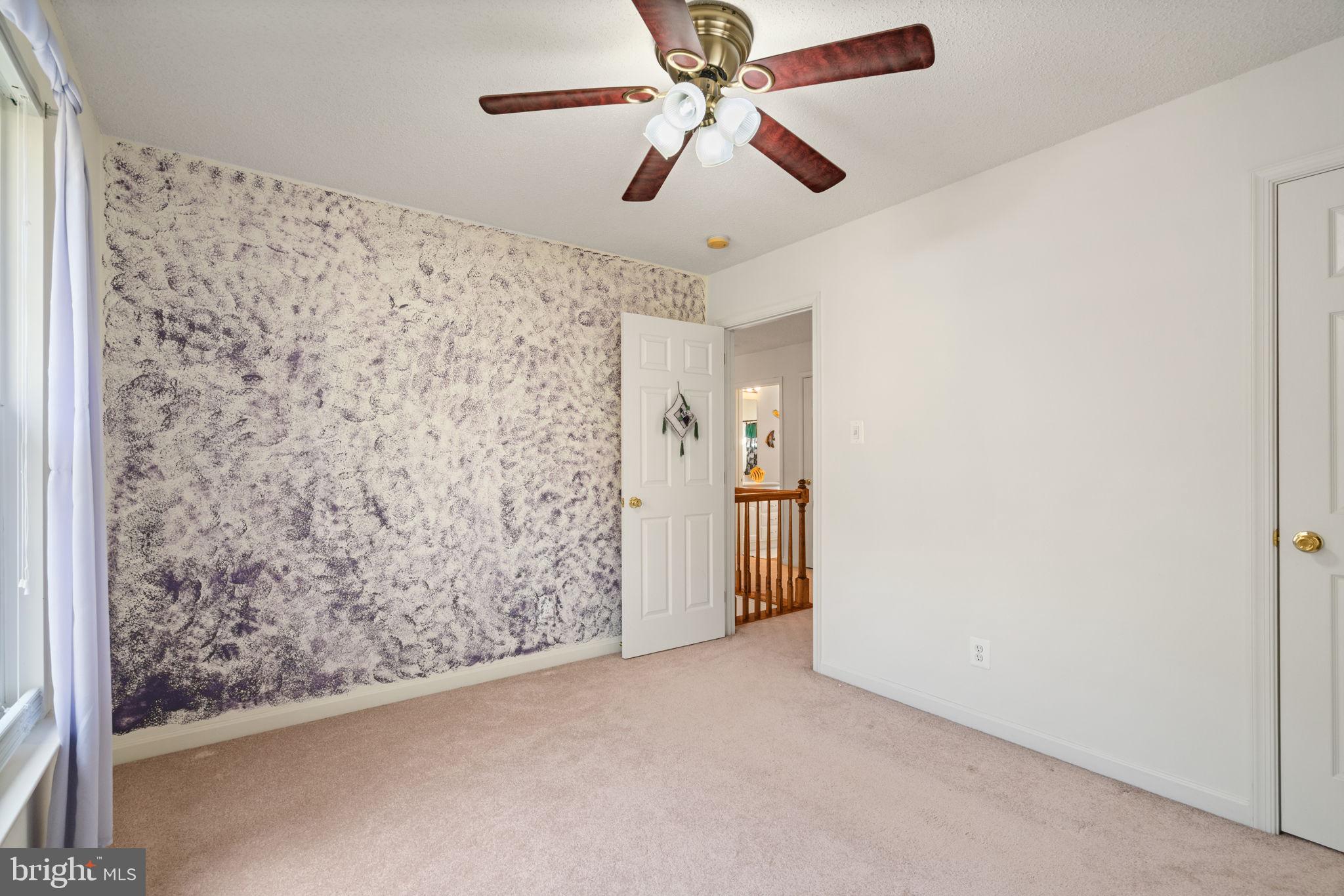 14760 Peach Tree Lane King George, VA 22485 - Photo 25 of 40 an empty room with a ceiling fan and a window