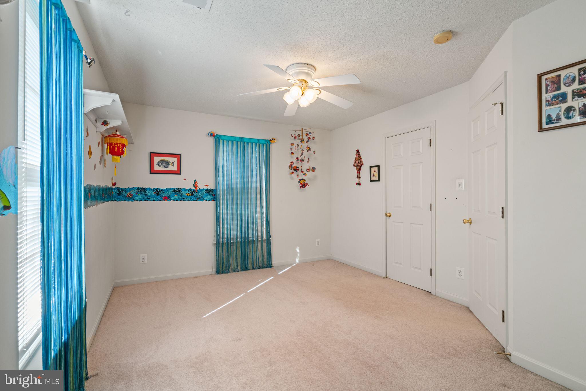 14760 Peach Tree Lane King George, VA 22485 - Photo 27 of 40 a bedroom with a bed and a chandelier