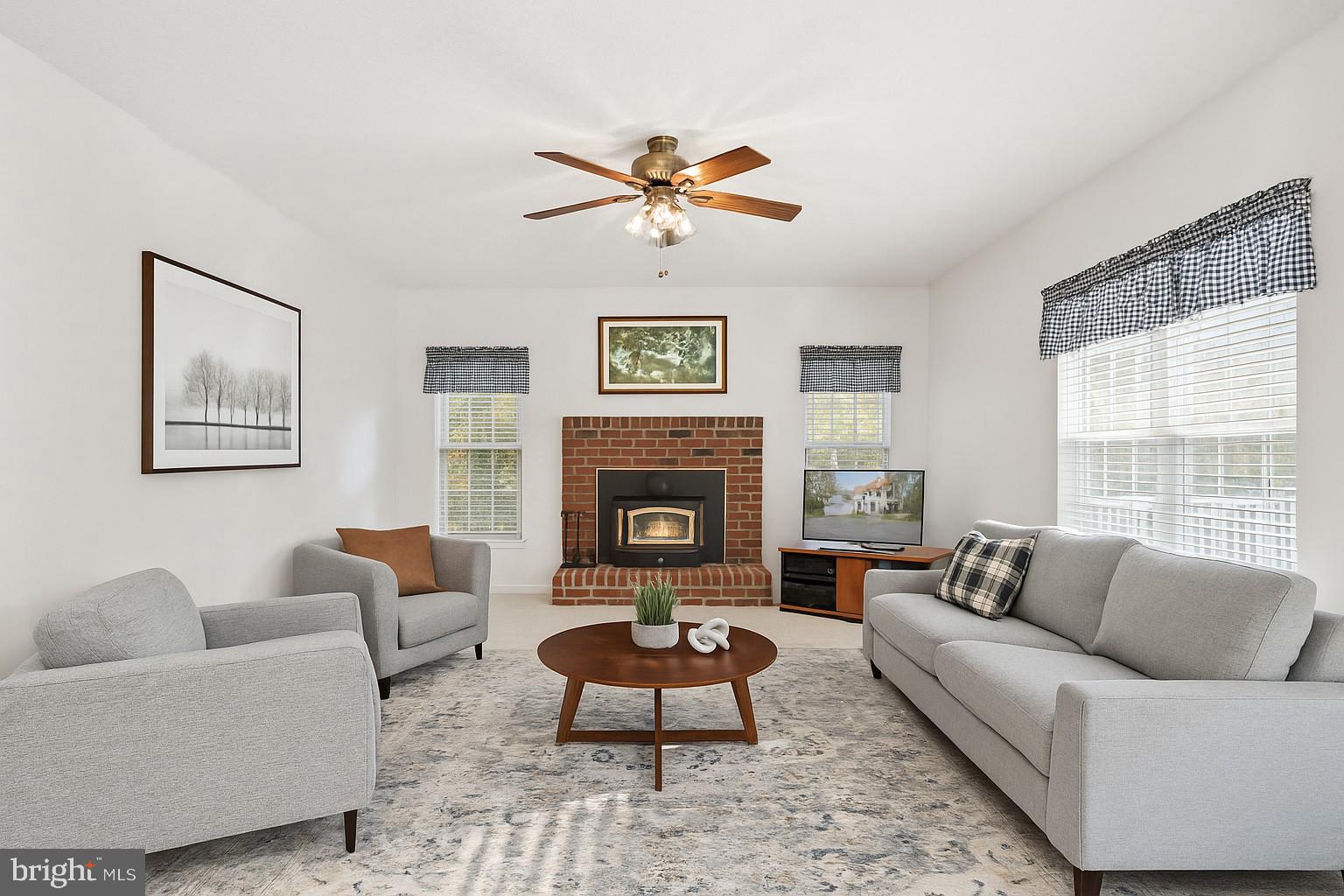 14760 Peach Tree Lane King George, VA 22485 - Photo 7 of 40 a living room with furniture a fireplace and a large window