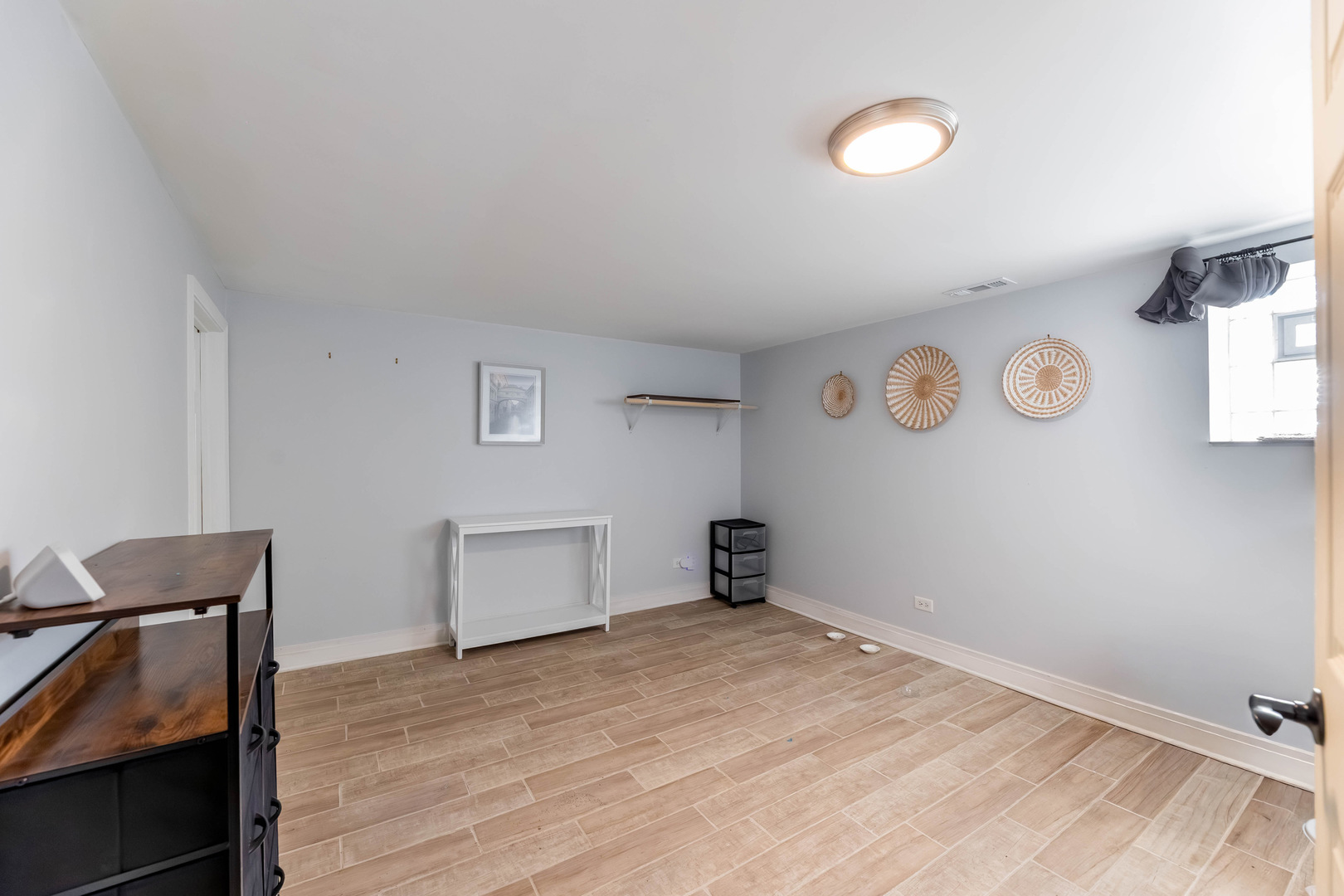 6358 South Keeler Avenue Chicago, IL 60629 - Photo 21 of 25 a view of empty room with a window and wooden floor