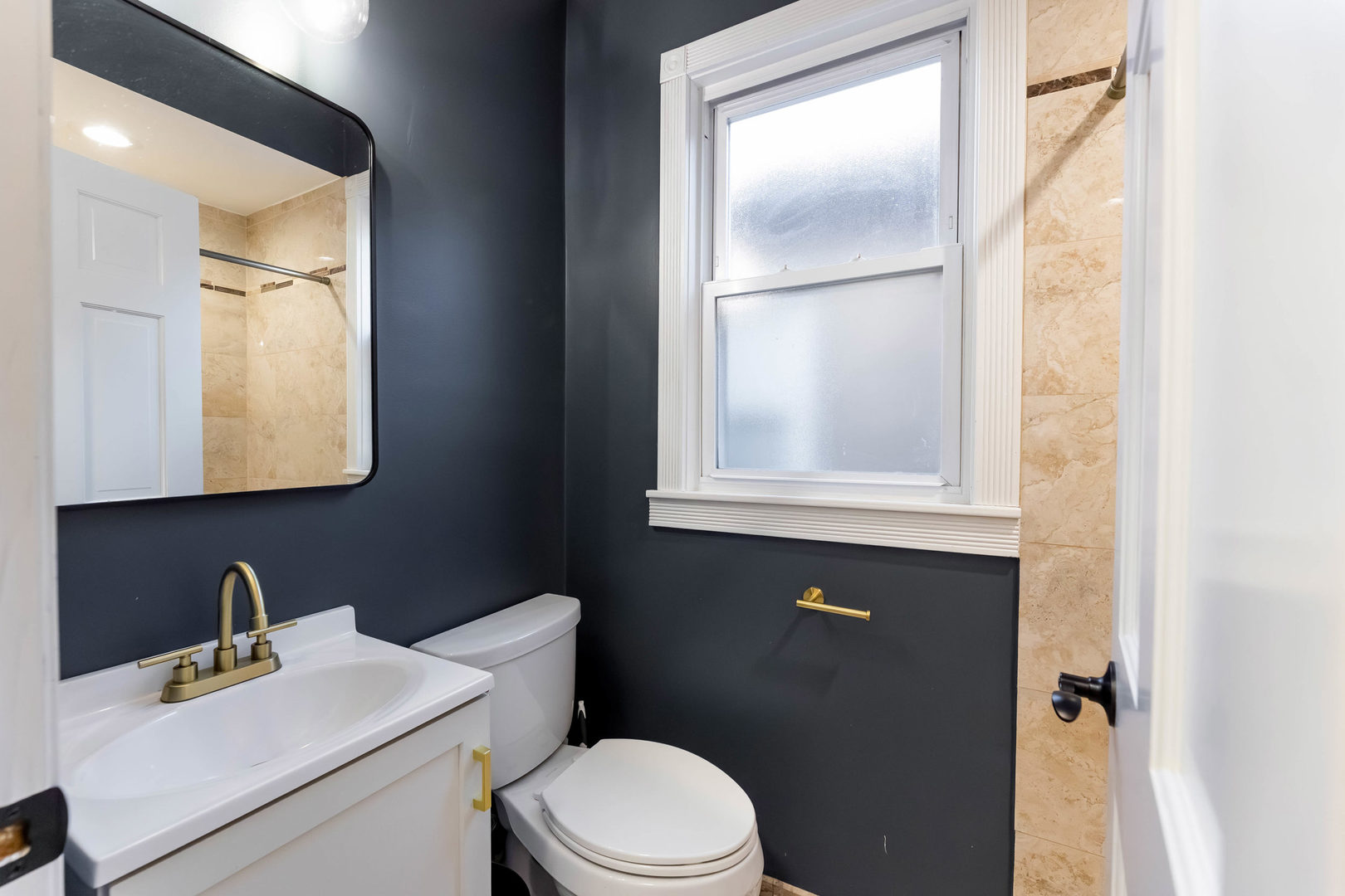 6358 South Keeler Avenue Chicago, IL 60629 - Photo 10 of 25 a bathroom with a sink vanity mirror and toilet