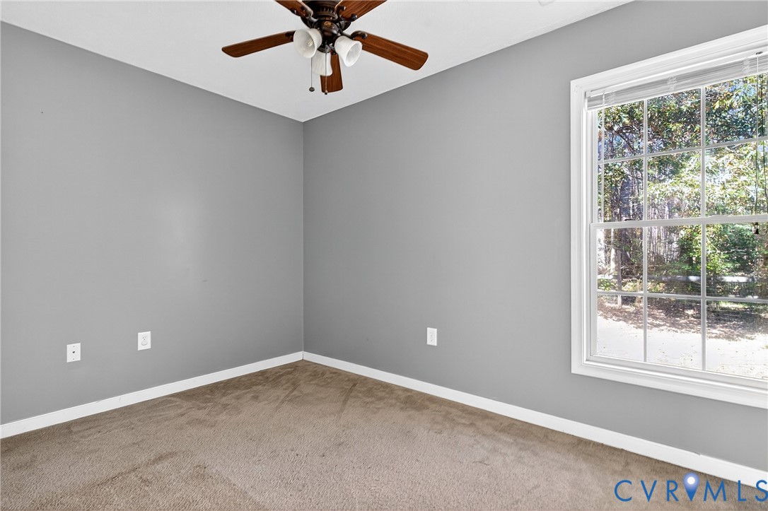 1611 Howerton Road Dunnsville, VA 22454 - Photo 12 of 36 an empty room with a window and a fan