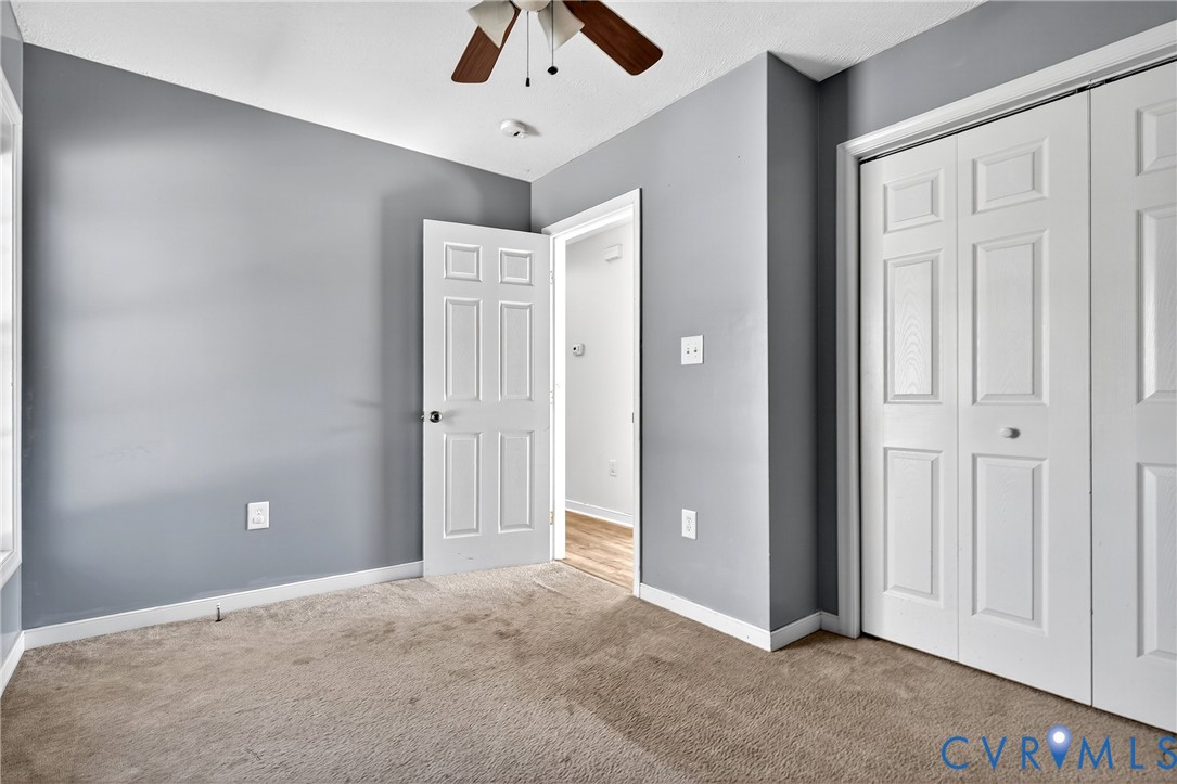 1611 Howerton Road Dunnsville, VA 22454 - Photo 13 of 36 an empty room with chandelier fan