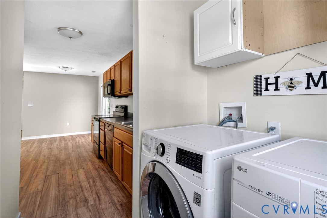 1611 Howerton Road Dunnsville, VA 22454 - Photo 19 of 36 a view of washer and dryer with kitchen in the background