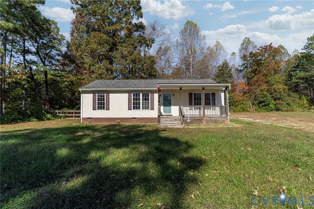 1611 Howerton Road Dunnsville, VA 22454 - Photo 2 of 36 a front view of a house with a yard