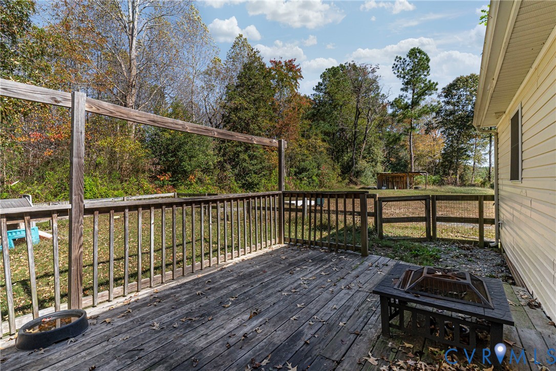 1611 Howerton Road Dunnsville, VA 22454 - Photo 21 of 36 a wooden bench sitting in front of a house