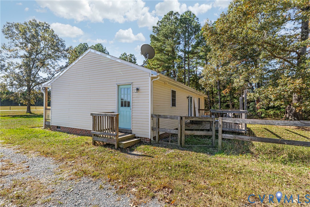 1611 Howerton Road Dunnsville, VA 22454 - Photo 27 of 36 a view of a house with backyard and chairs