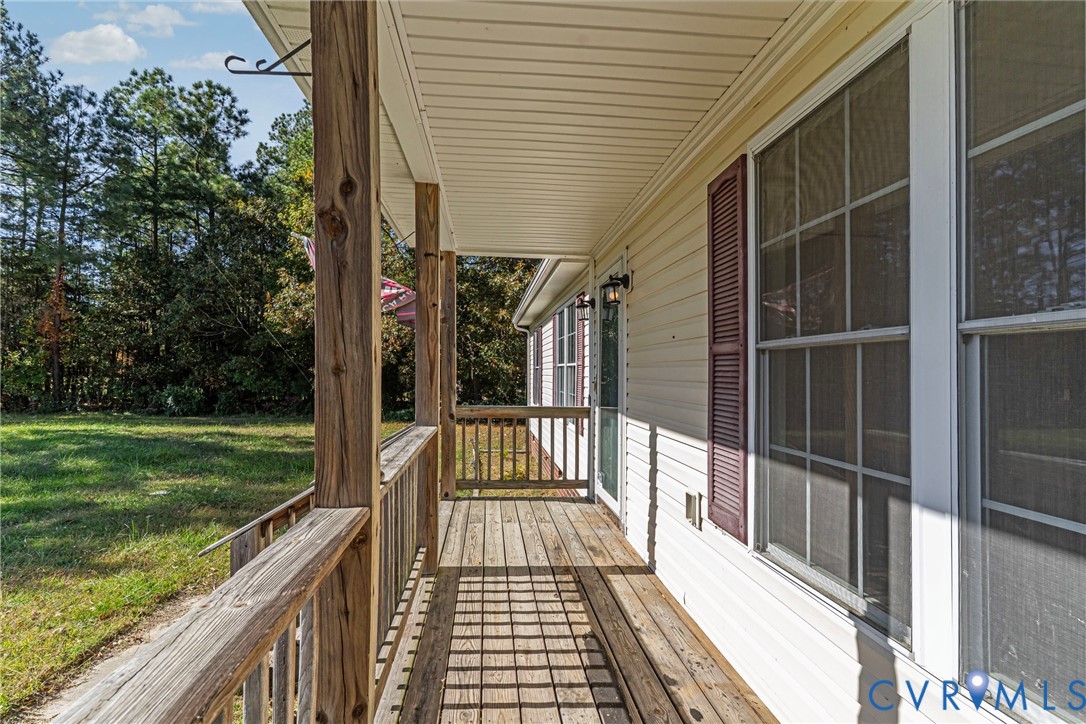 1611 Howerton Road Dunnsville, VA 22454 - Photo 28 of 36 a view of a balcony with wooden floor