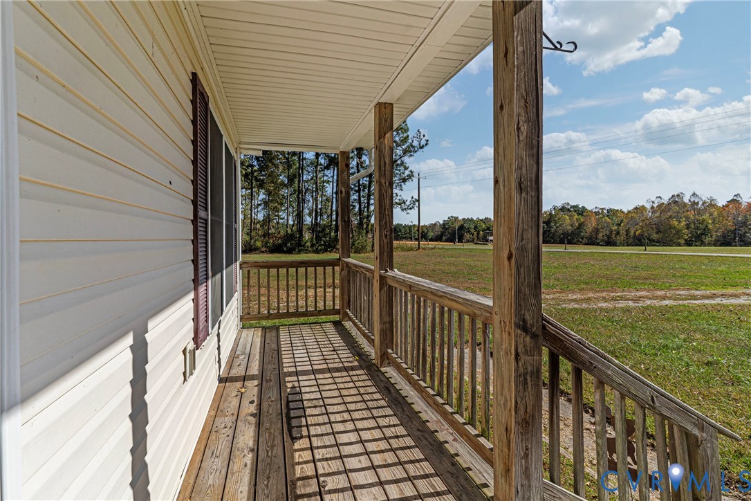 1611 Howerton Road Dunnsville, VA 22454 - Photo 29 of 36 a view of balcony with wooden floor