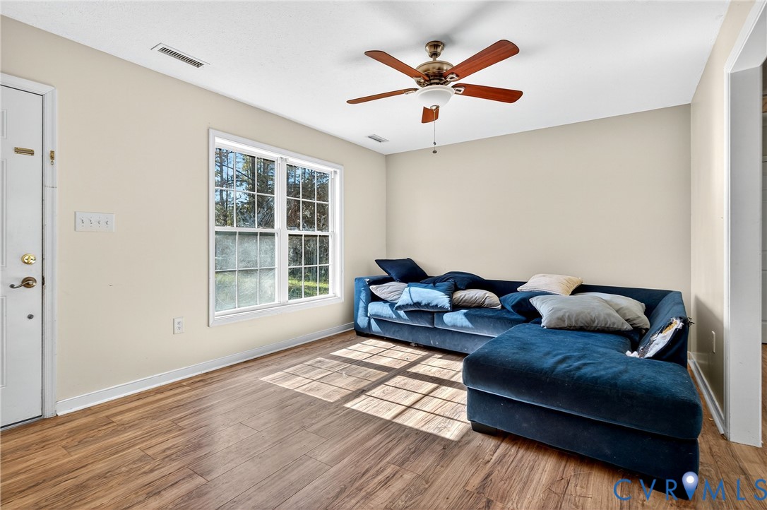 1611 Howerton Road Dunnsville, VA 22454 - Photo 3 of 36 a living room with furniture and a large window