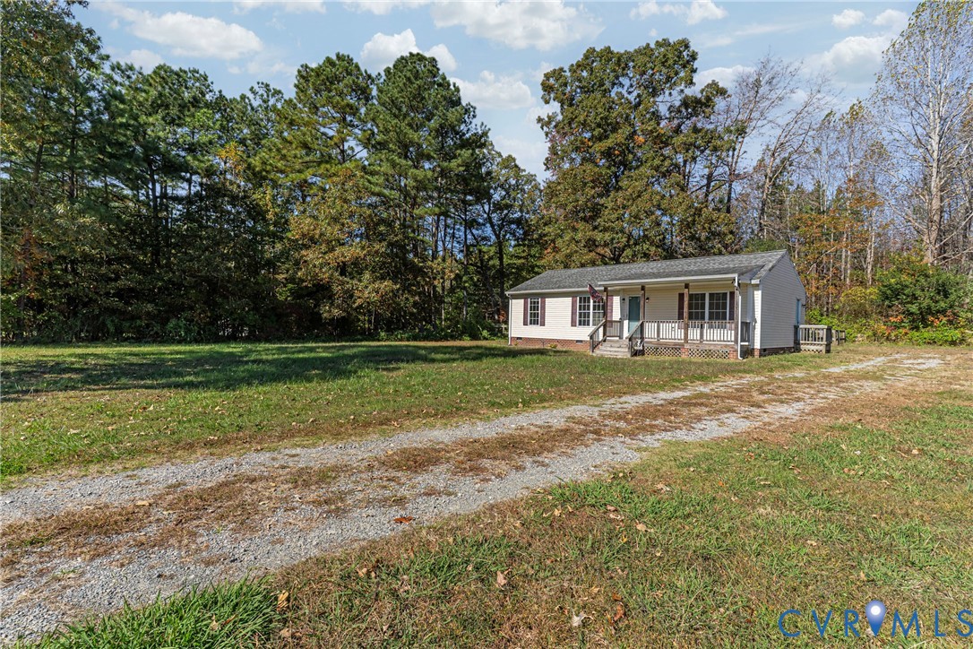 1611 Howerton Road Dunnsville, VA 22454 - Photo 31 of 36 a front view of a house with yard and green space