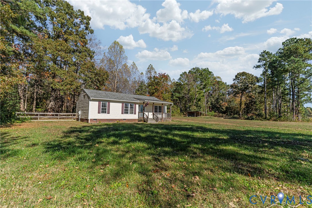 1611 Howerton Road Dunnsville, VA 22454 - Photo 32 of 36 a front view of a house with a garden