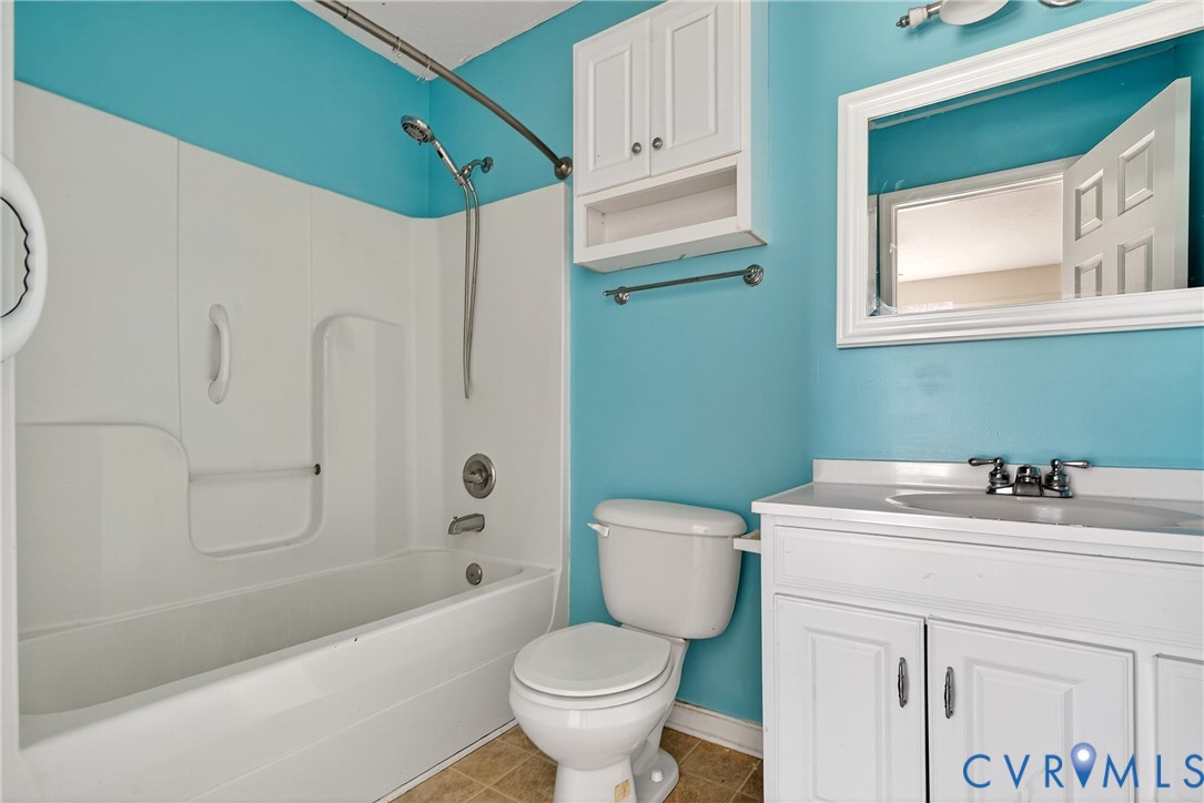 1611 Howerton Road Dunnsville, VA 22454 - Photo 8 of 36 a bathroom with a sink toilet and shower