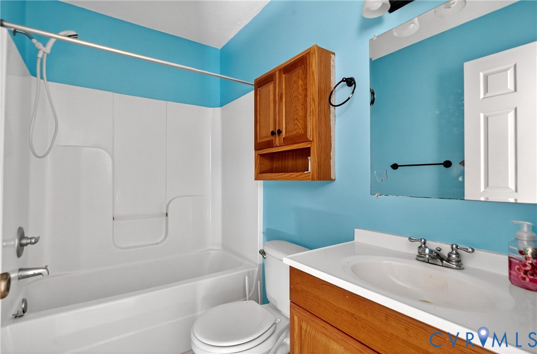1611 Howerton Road Dunnsville, VA 22454 - Photo 9 of 36 a bathroom with a sink toilet and shower
