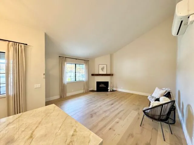 a spacious bedroom with a bed and a fireplace