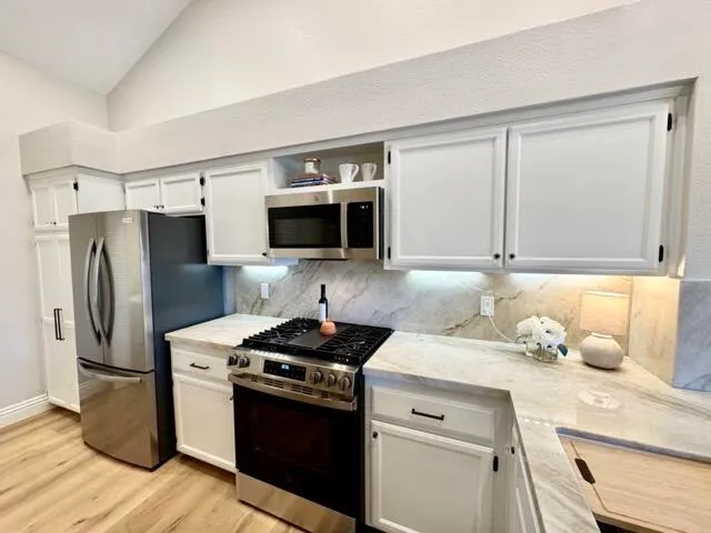a kitchen with stainless steel appliances a refrigerator stove and sink