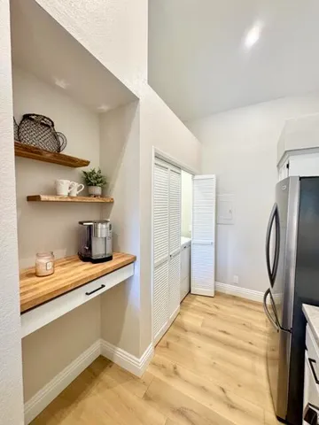 a room with a refrigerator and cabinets