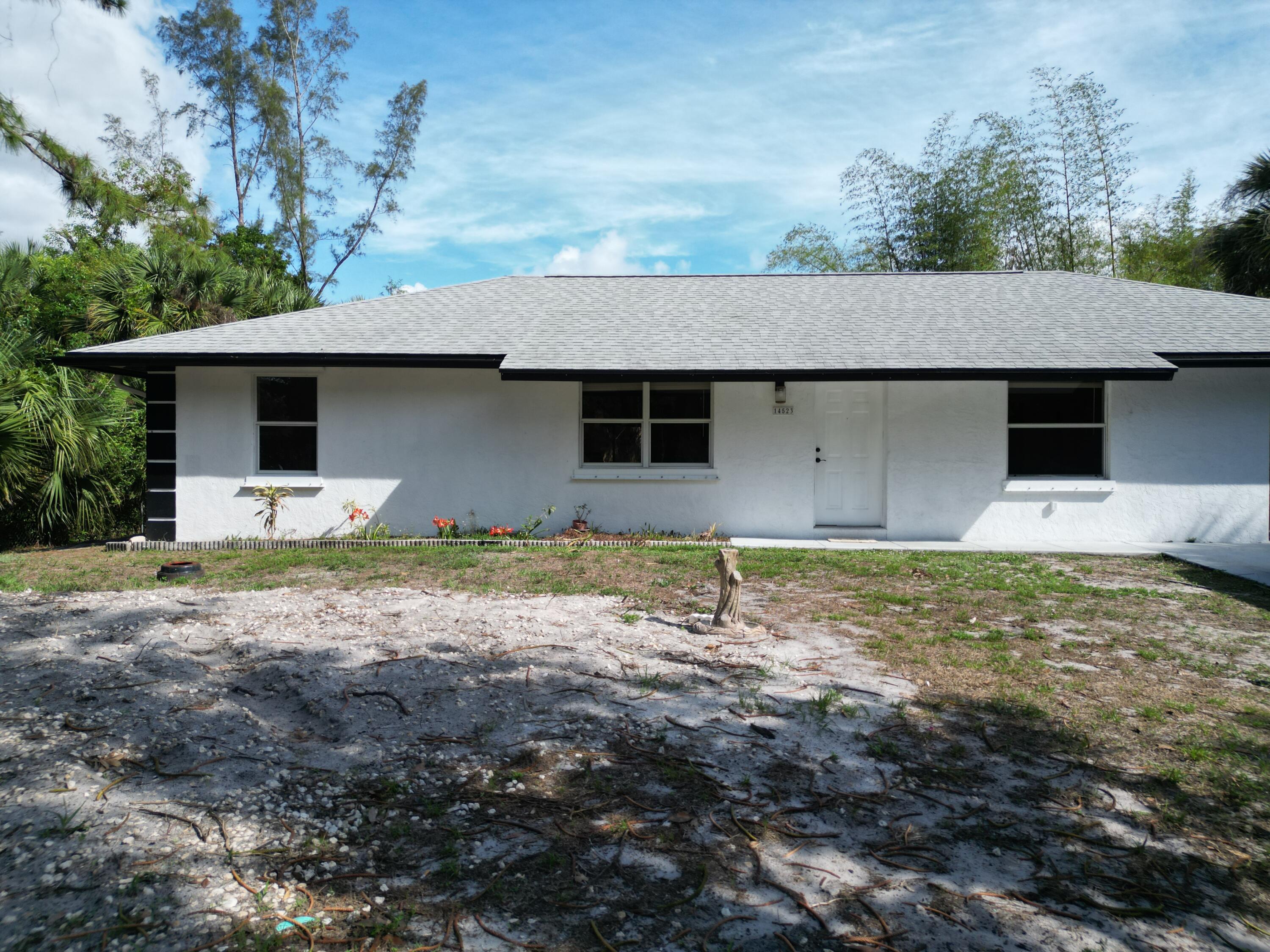 14523 Flamingo Road Loxahatchee Groves, FL 33470 - Photo 3 of 50 a front view of house with yard