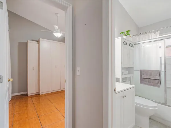 a view of a hallway with closet and a window