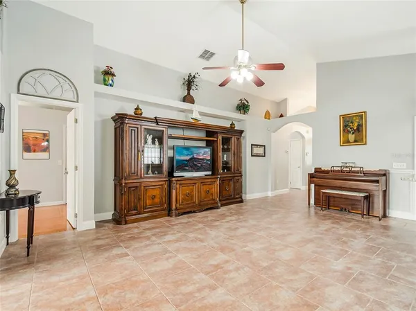 a view of a livingroom with furniture and a ceiling fan