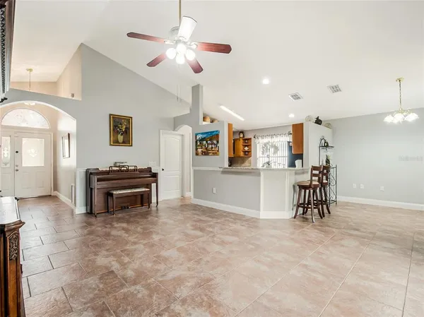 a view of a livingroom with furniture and a ceiling fan