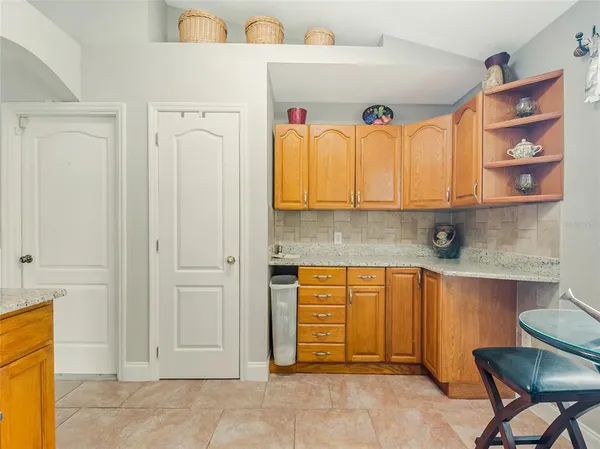 a kitchen with granite countertop a sink cabinets and stainless steel appliances