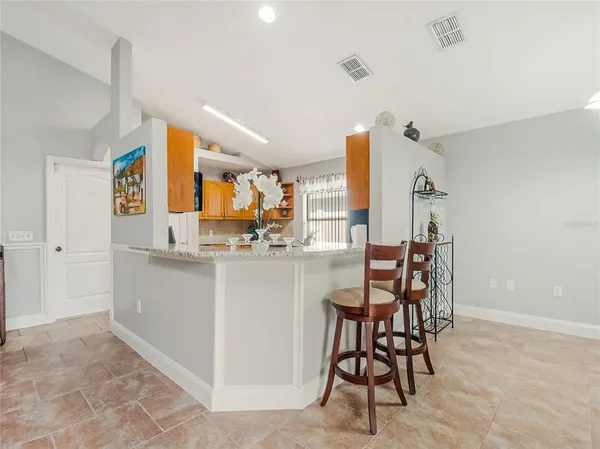 a view of a dining room with furniture and a chandelier