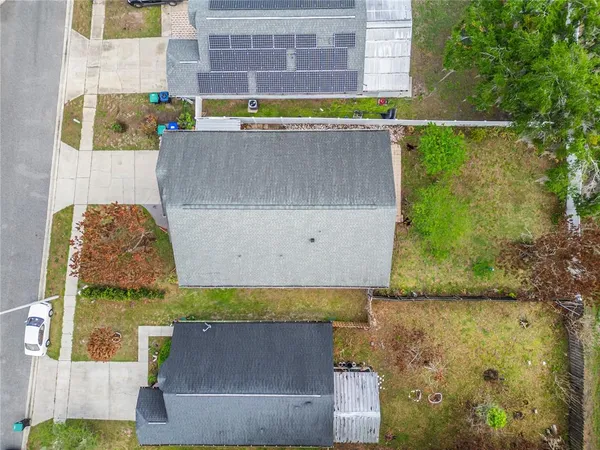 an aerial view of a house with outdoor space swimming pool