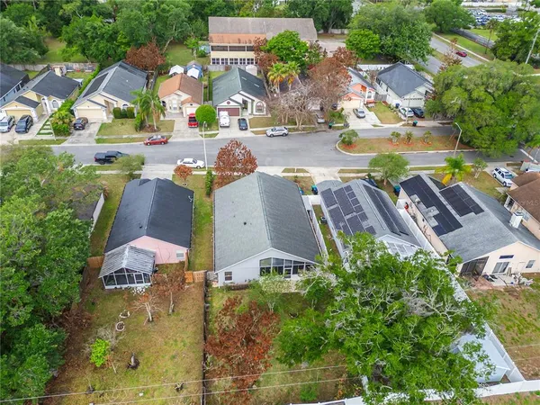 an aerial view of a house with a yard