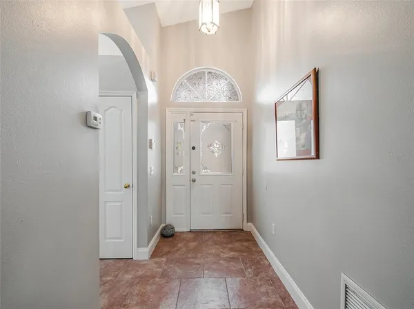 a view of a hallway with closet and a window