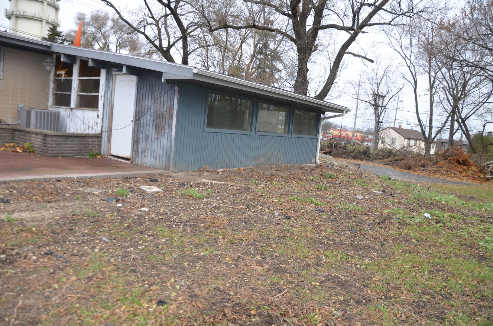 1225 Plainfield Road Darien, IL 60561 - Photo 8 of 14 a backyard of a house with large trees and brick wall
