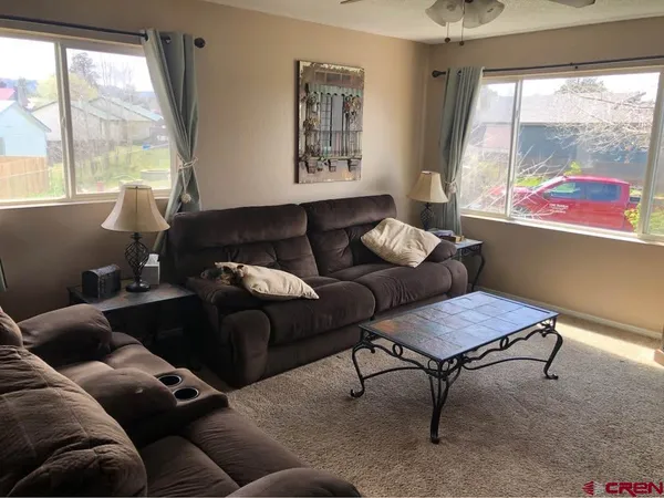 a living room with furniture and a large window