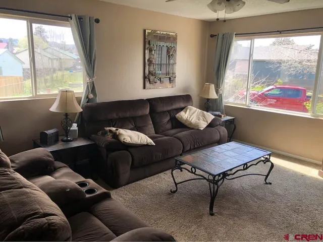 a living room with furniture and a large window