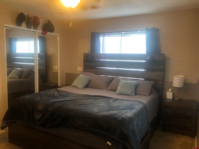 a bed sitting in a bedroom next to a window