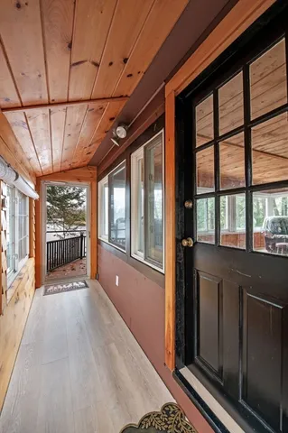 a view of hallway with wooden floor