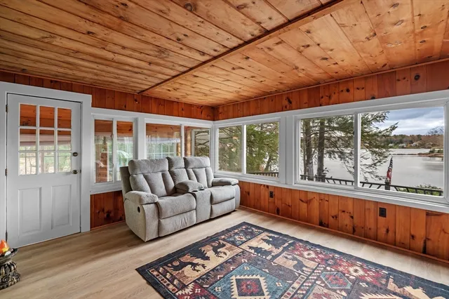 a living room with furniture and large windows