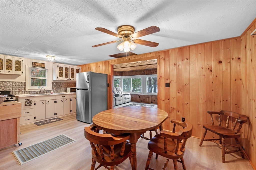 288 Pinkham Road Middleton, NH 03887 - Photo 25 of 42 a view of a dining room with furniture and a chandelier