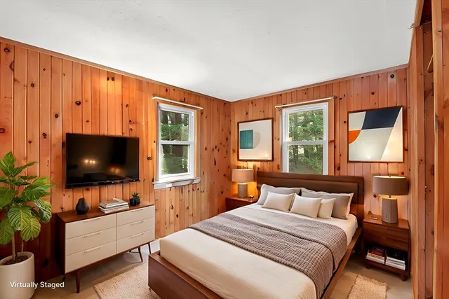 a bedroom with a bed and a flat screen tv