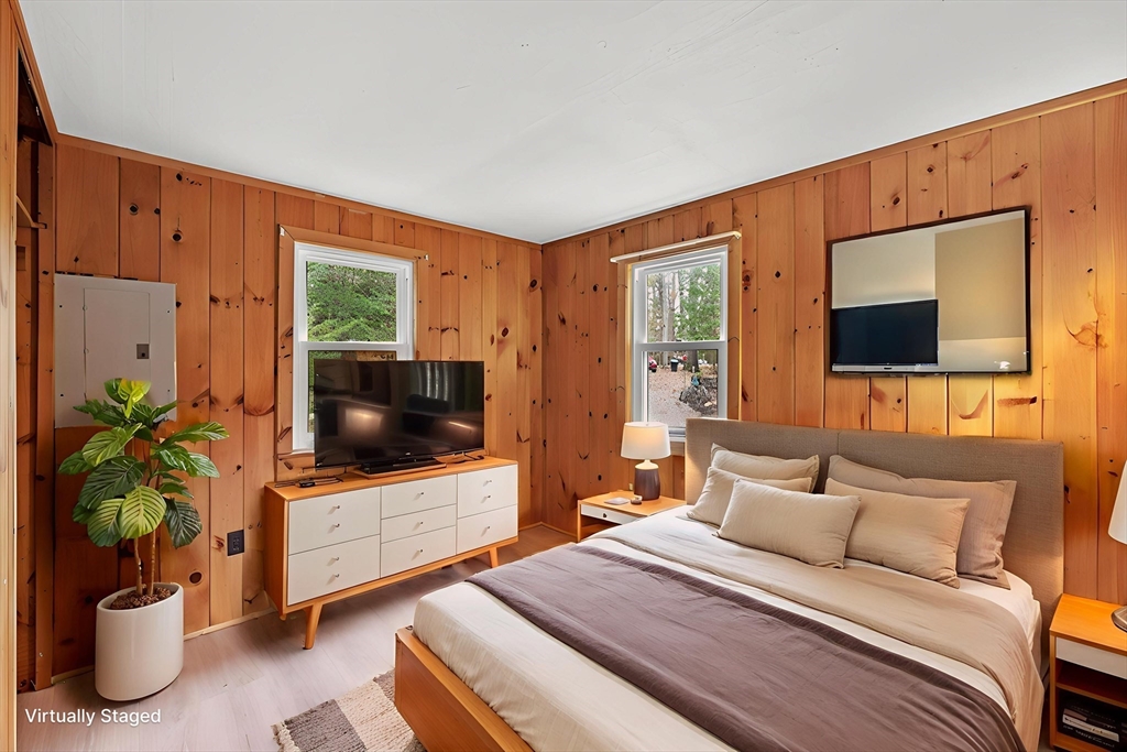 288 Pinkham Road Middleton, NH 03887 - Photo 40 of 42 a bedroom with a bed and a flat screen tv