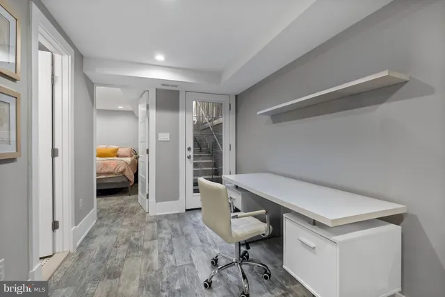 a bed sitting in a bedroom next to a window