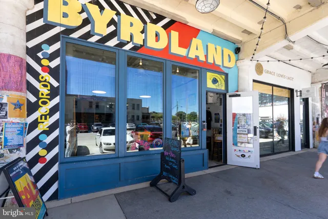 a roof deck with table and chairs potted plants