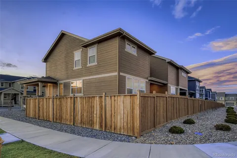 a view of a house with wooden fence