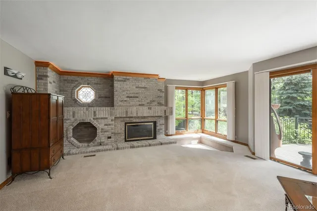 an empty room with furniture and a fireplace