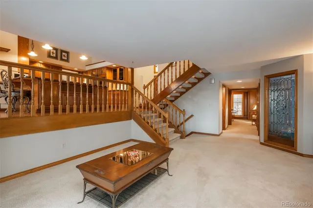 a living room with furniture a flat screen tv and a window