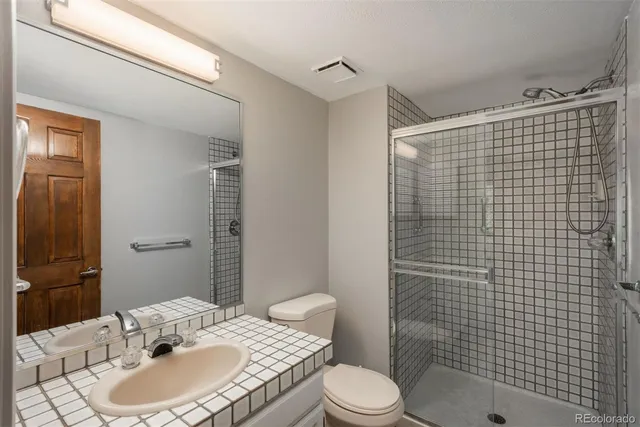 a spacious bedroom with a bed and a large window